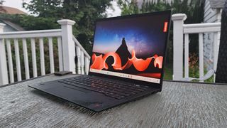 Lenovo ThinkPad X1 Carbon Gen 11 open on an outdoor table